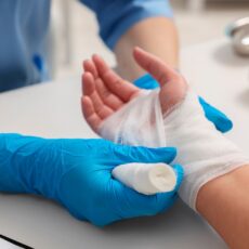 Nurse bandaging wrist